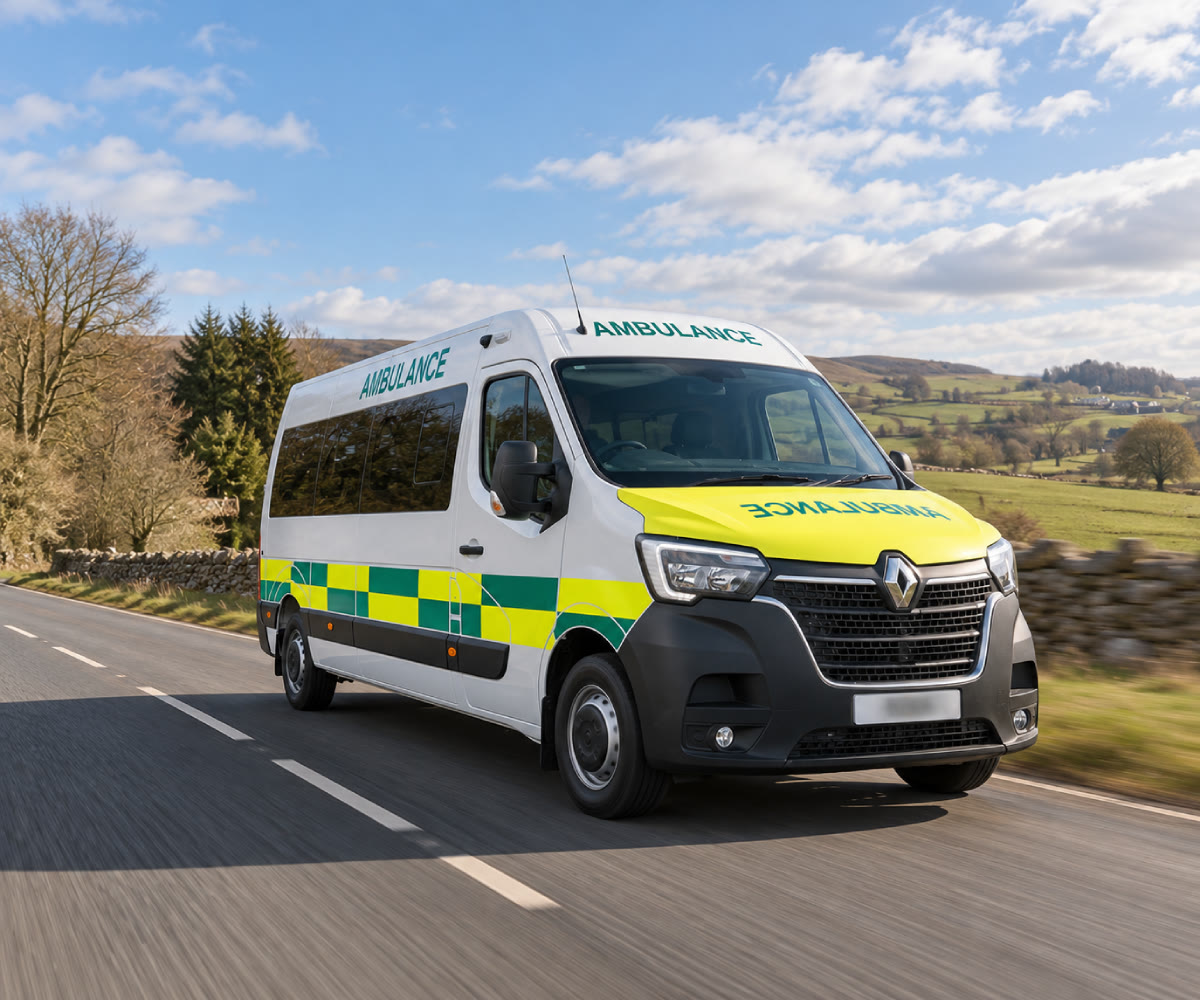 White patient transport ambulance travelling on the road